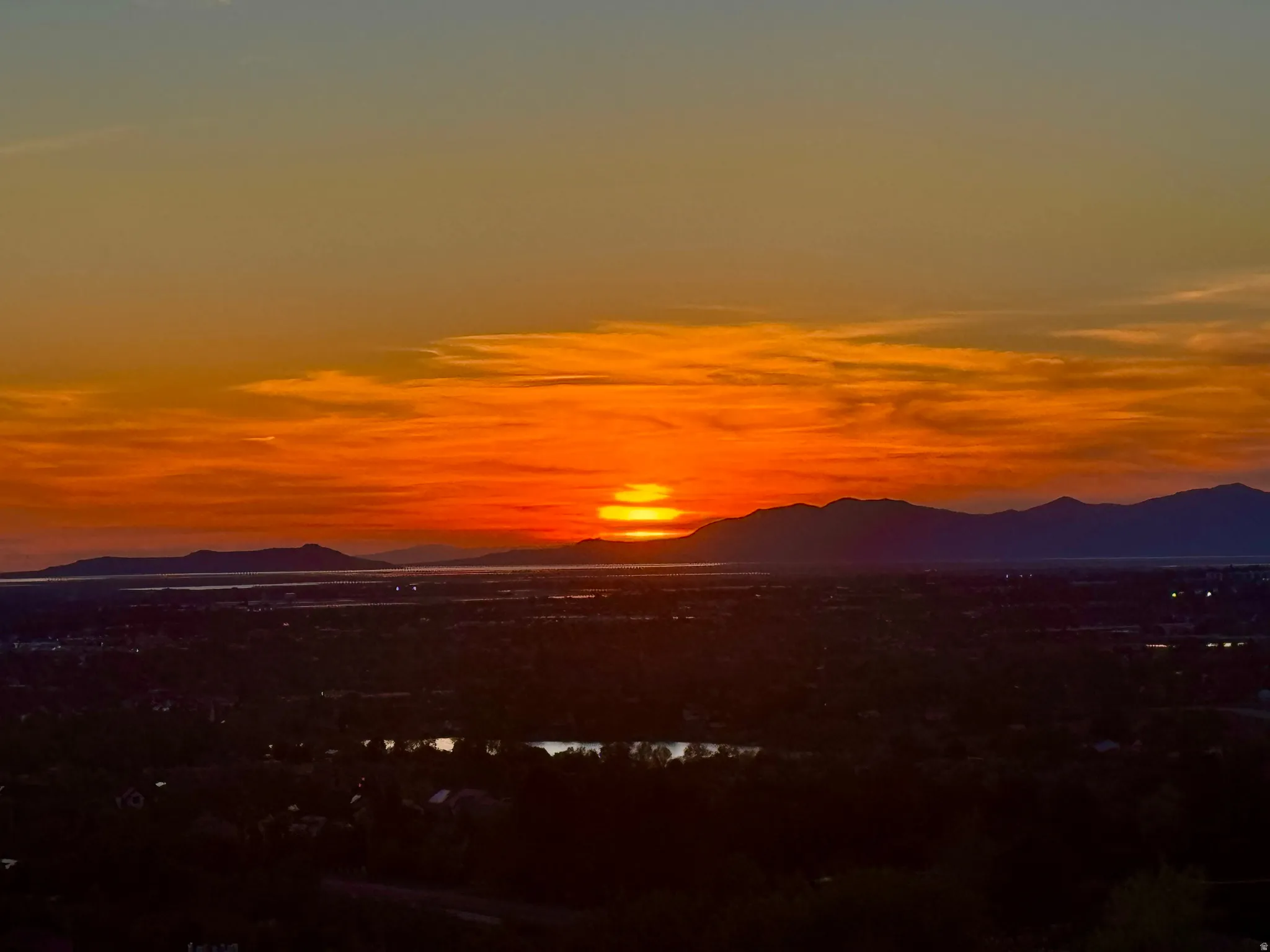Dramatic sunset over Antelope Island and water