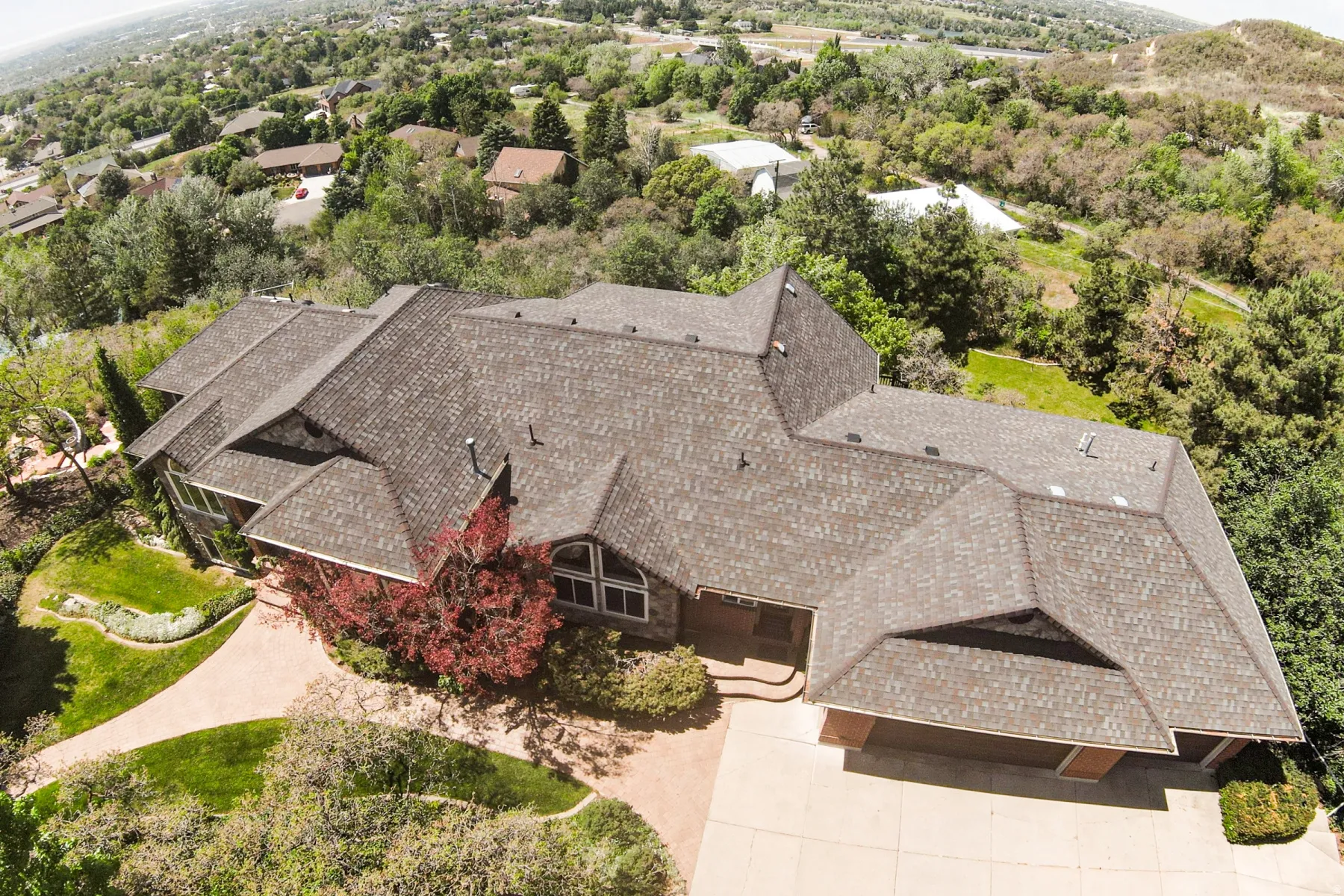 Property exterior featuring a multi-gabled roofline and a concrete driveway