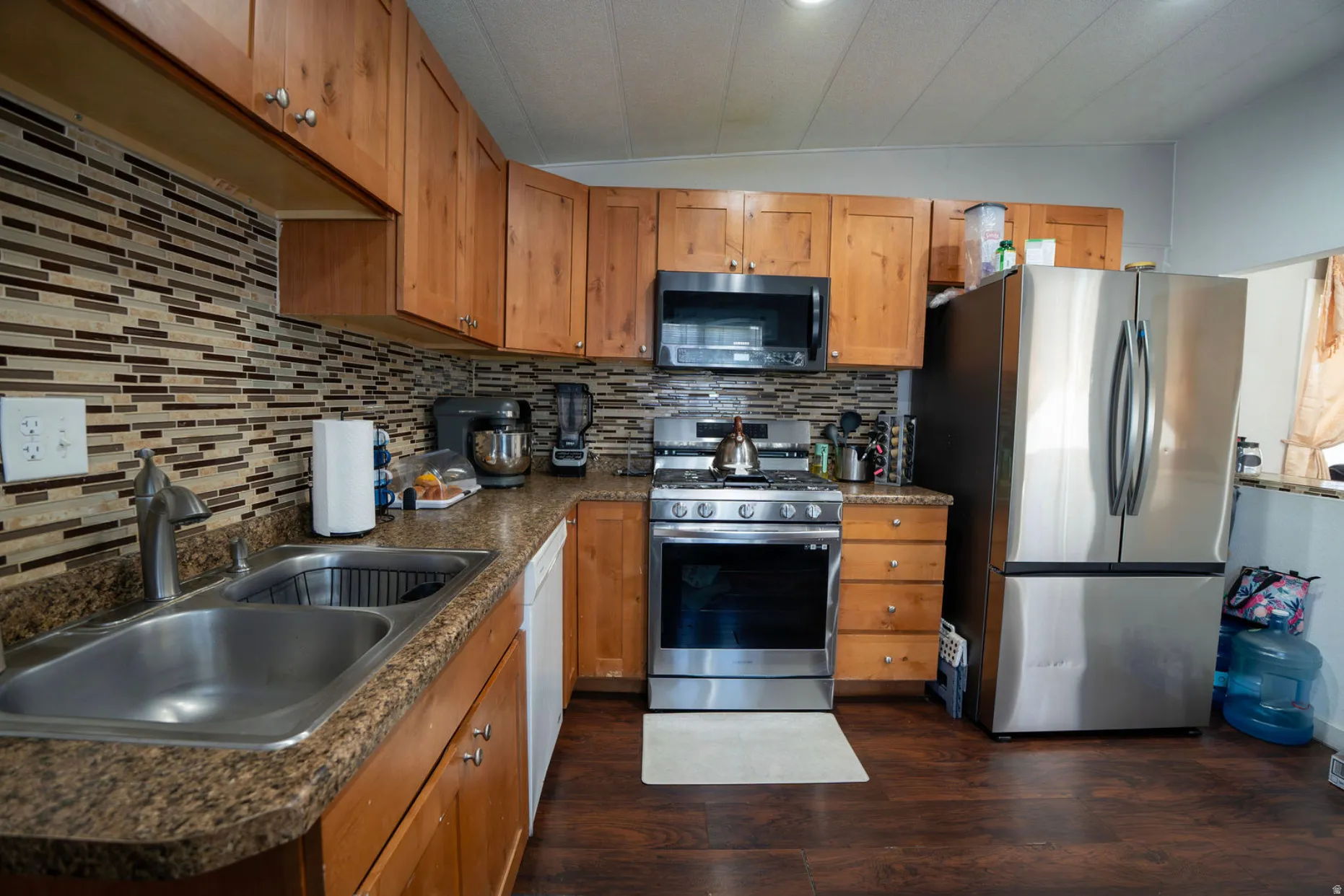Kitchen featuring wood-finish flooring and a stone-finish countertop