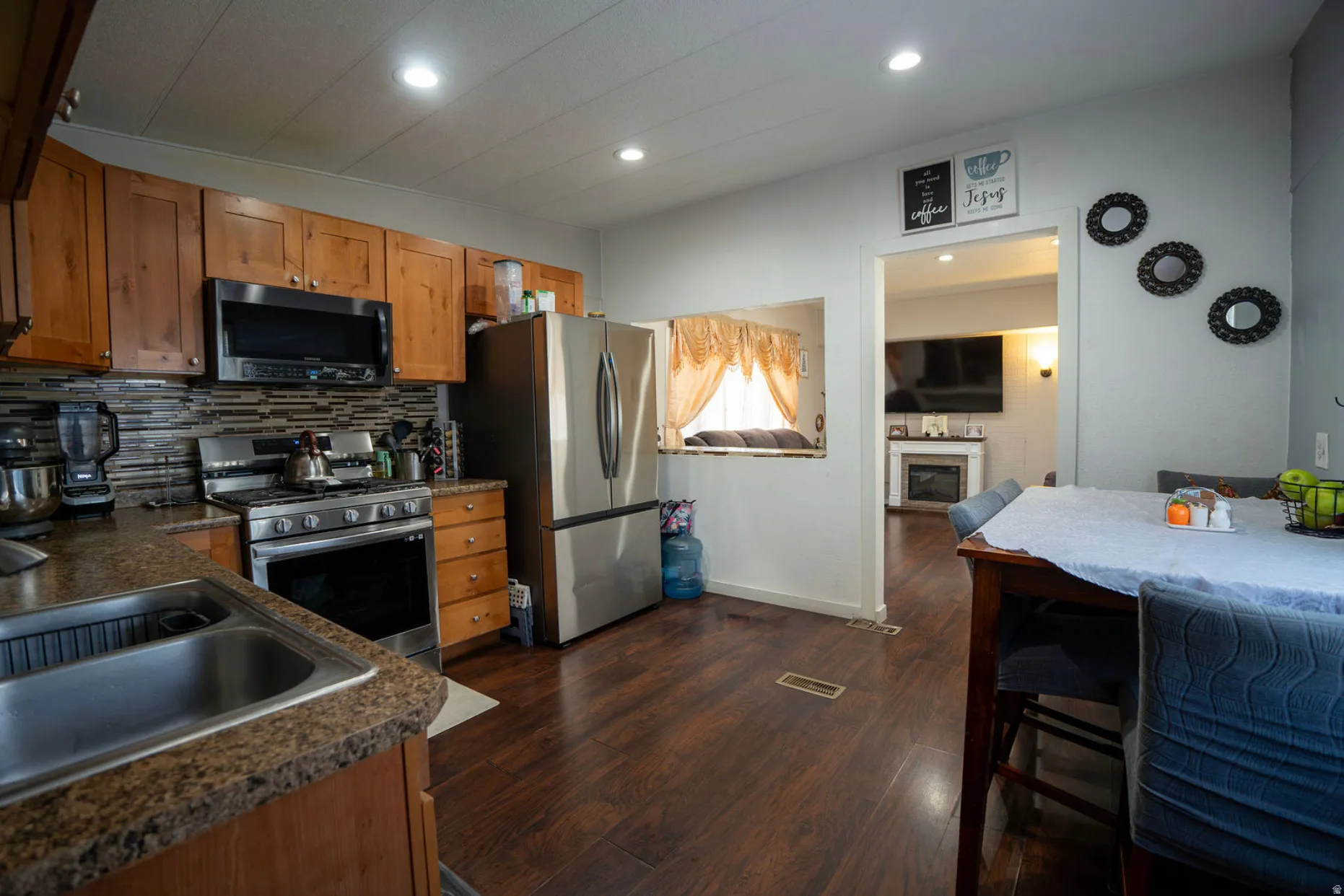 Kitchen featuring wood-finish flooring, recessed lighting, and a pass-through window