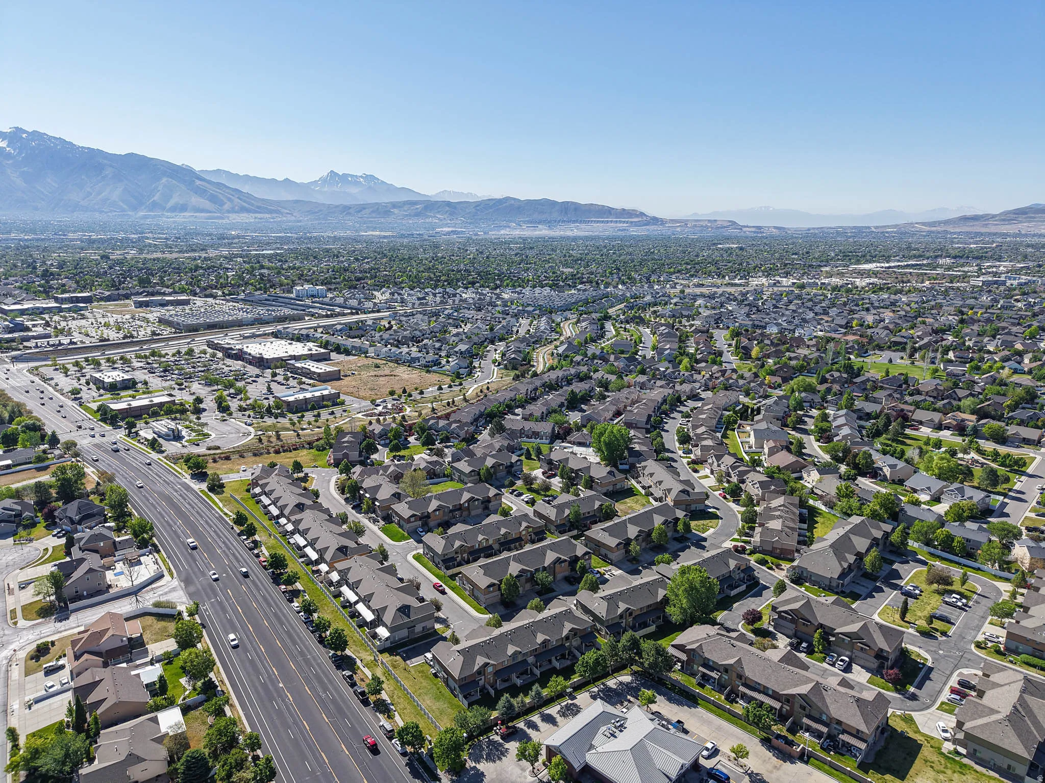 Expansive aerial perspective showcasing a residential community with varied rooflines and mature landscaping