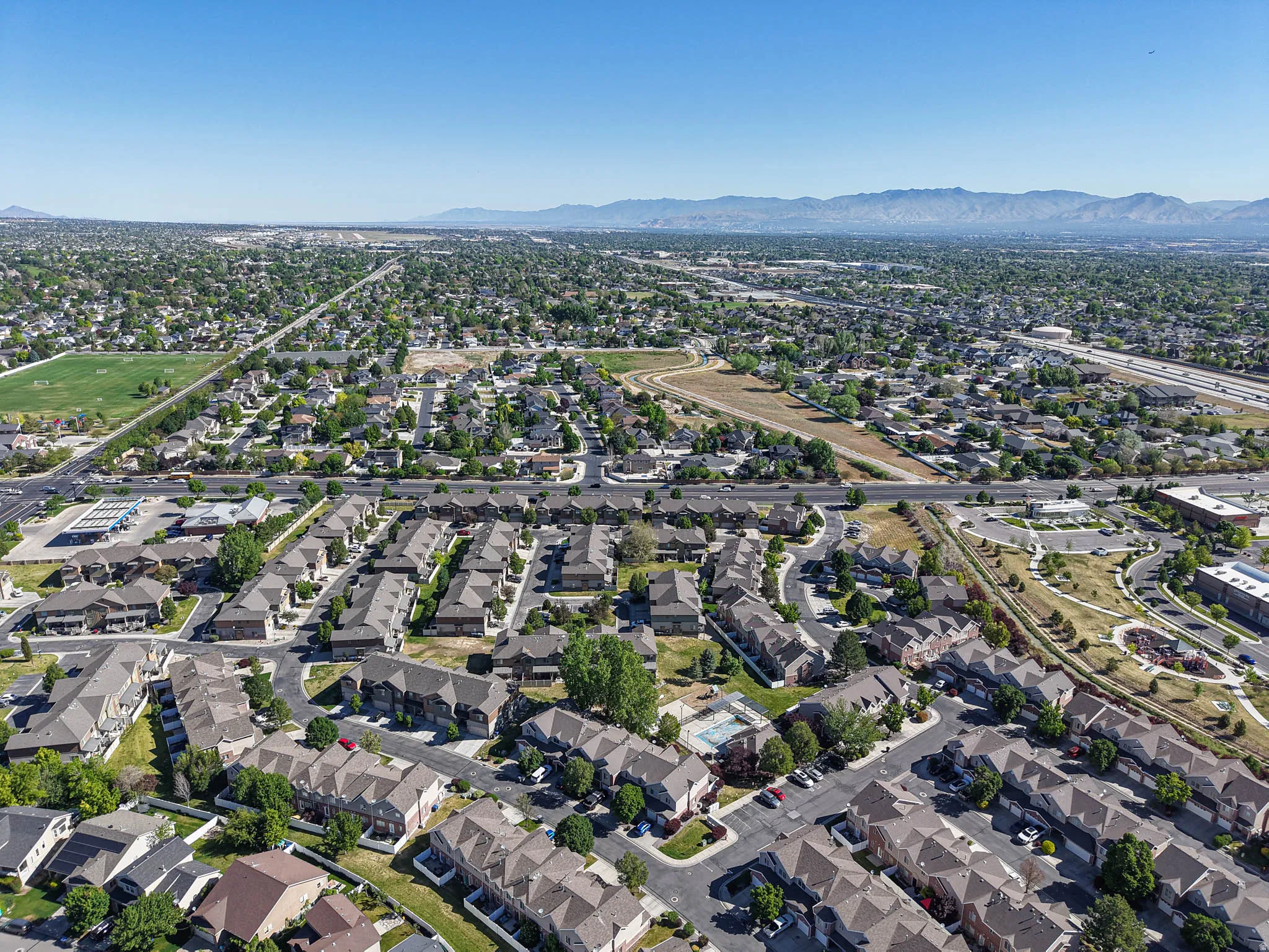 Expansive residential area with a clear sky backdrop and distant mountain range
