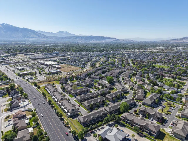 Expansive aerial perspective showcasing a residential community with varied rooflines and mature landscaping