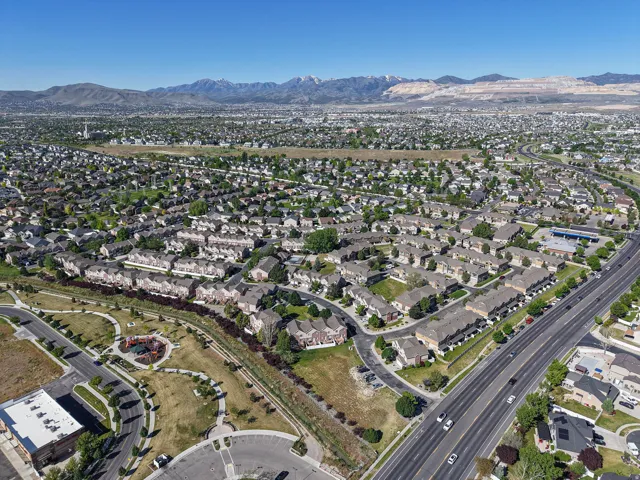 Expansive aerial perspective showcasing a residential development with a mountain backdrop