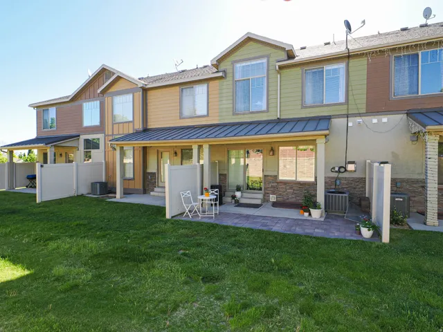 Expansive green lawn with private fenced patio areas