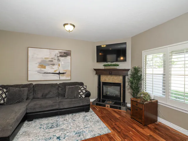 Corner fireplace with a wood-finish mantel and stone surround