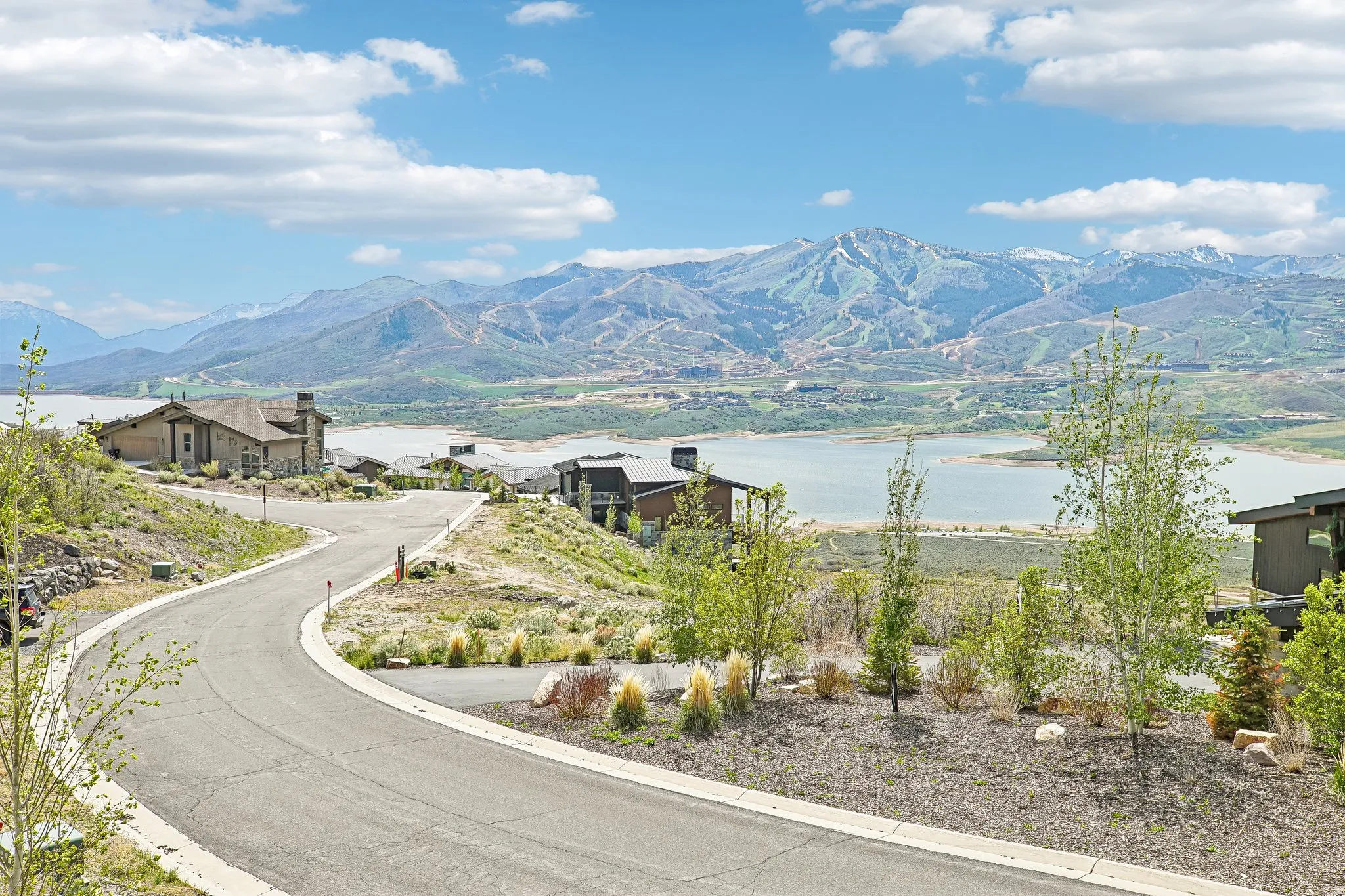 Paved road with mountain and lake backdrop