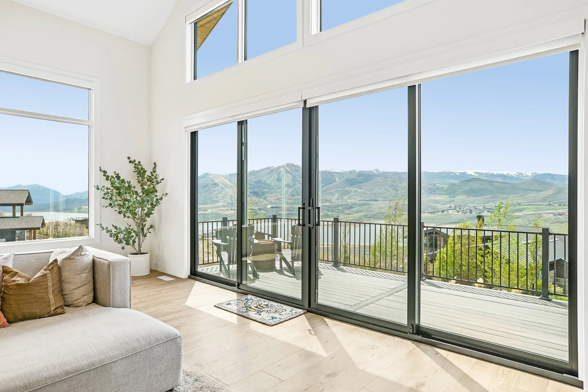 Spacious living area featuring expansive sliding glass doors opening to a large outdoor deck