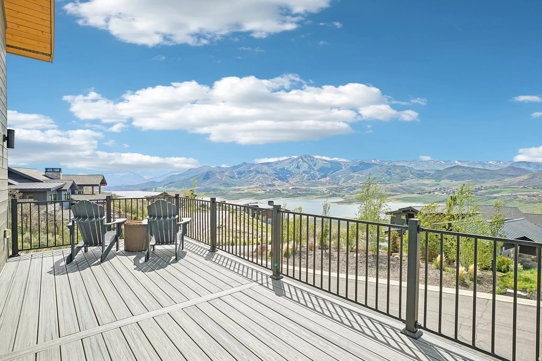 Expansive outdoor deck featuring wood-finish flooring and black metal railings