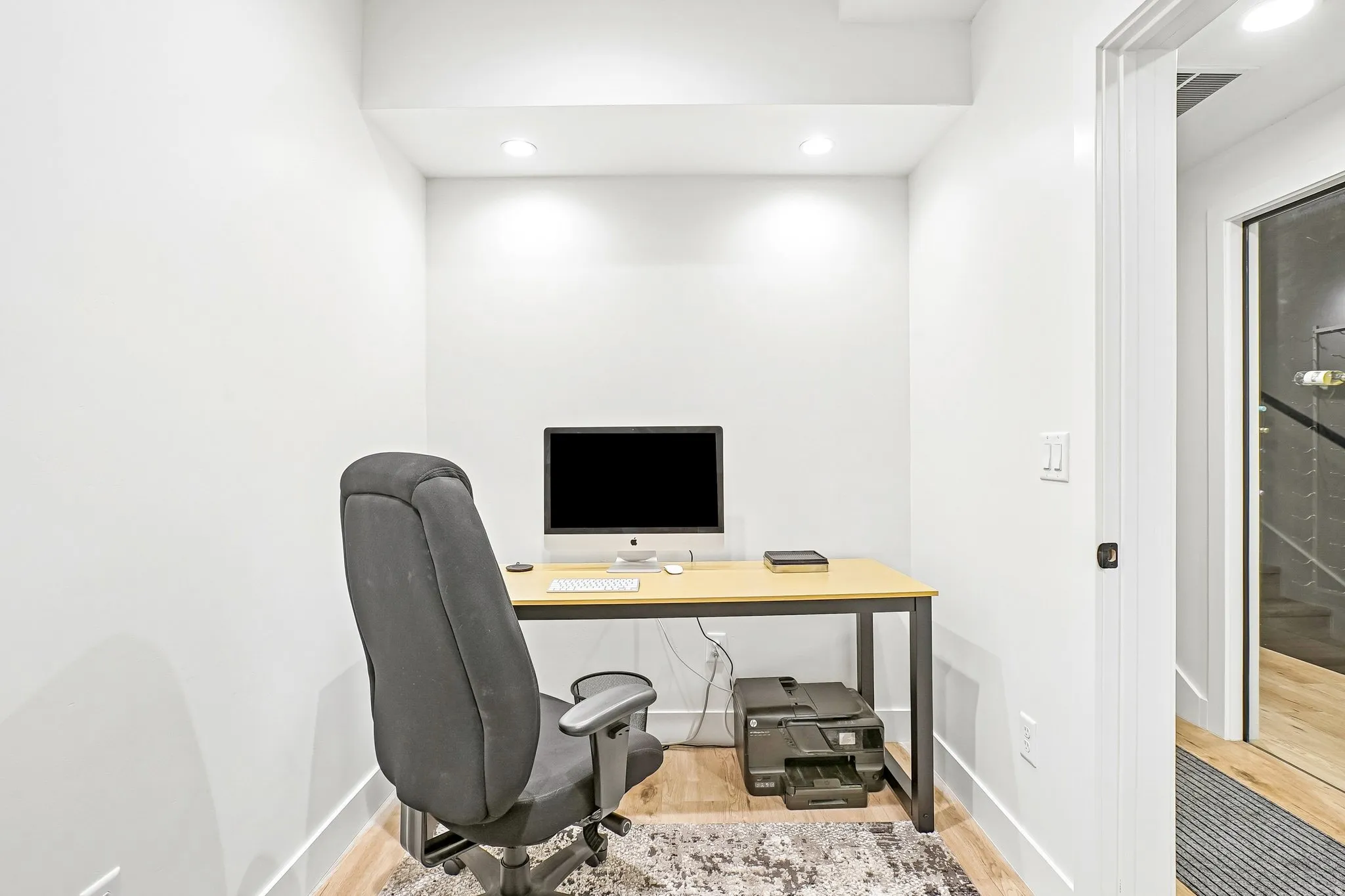 Dedicated workspace featuring recessed lighting and wood-finish flooring