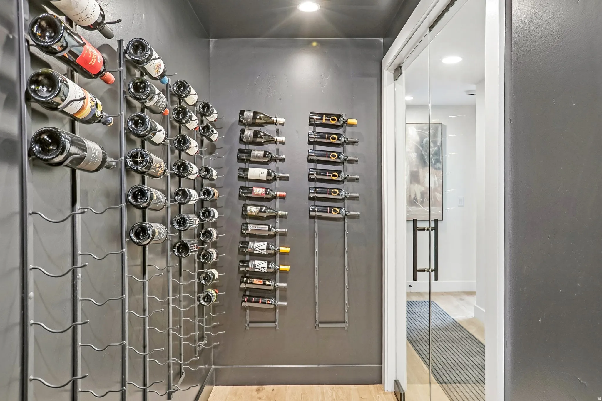 Dedicated wine storage area featuring extensive wall-mounted metal racking