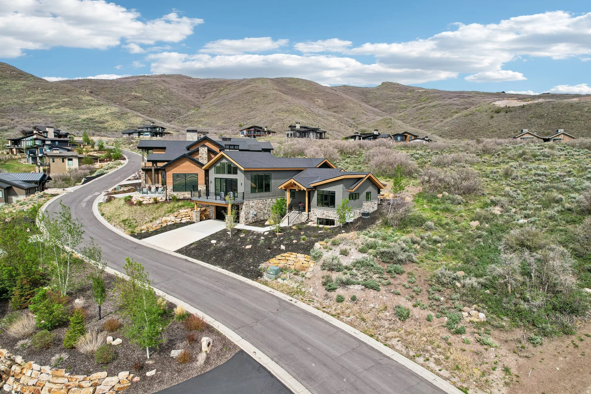 Modern mountain residence featuring a stone and wood facade