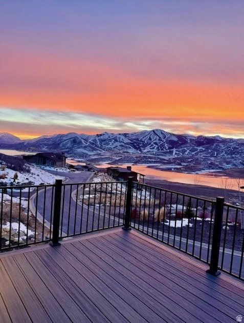 Spacious outdoor deck featuring composite decking and black metal railings