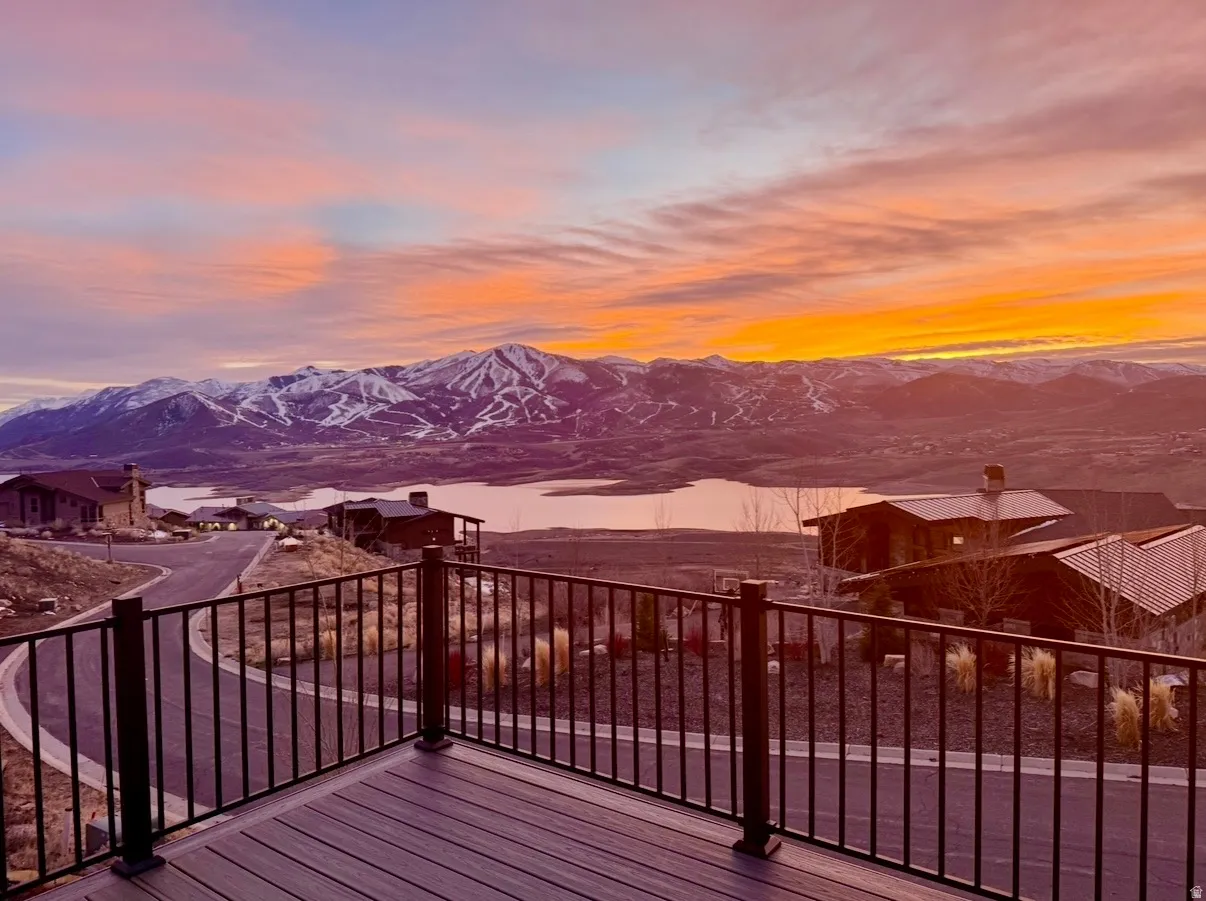 Expansive outdoor decking featuring composite wood-finish boards and a black metal railing