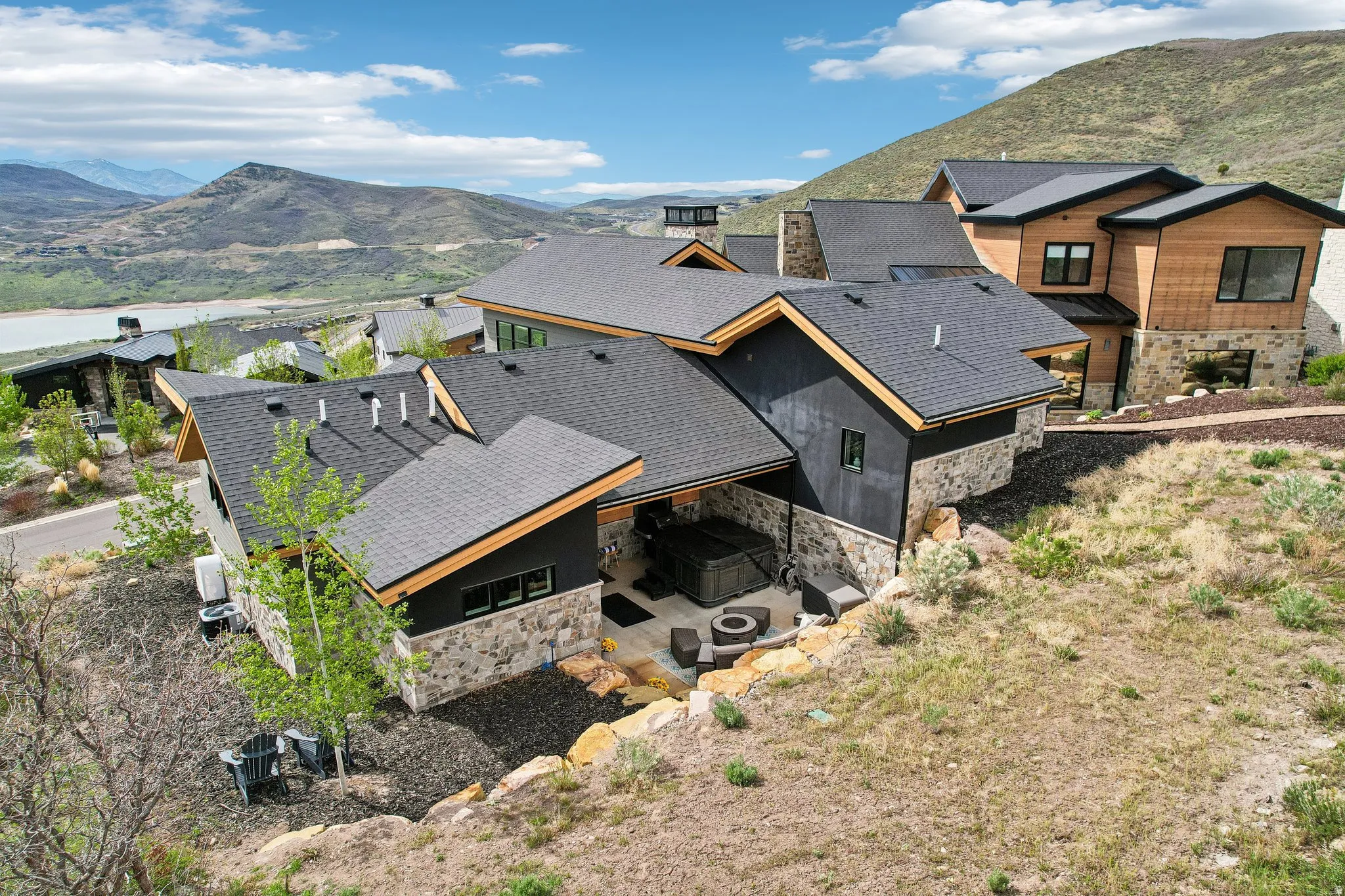 Modern mountain residence featuring a multi-level design with stone and wood paneling