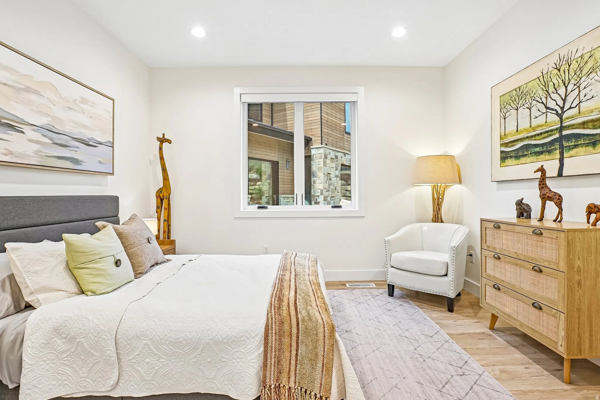 Light-filled room featuring recessed lighting, a single window, and wood-finish flooring