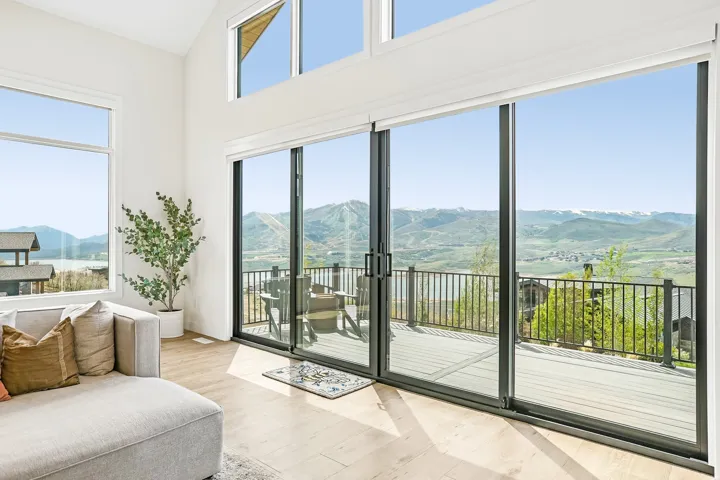 Spacious living area featuring expansive sliding glass doors opening to a large outdoor deck