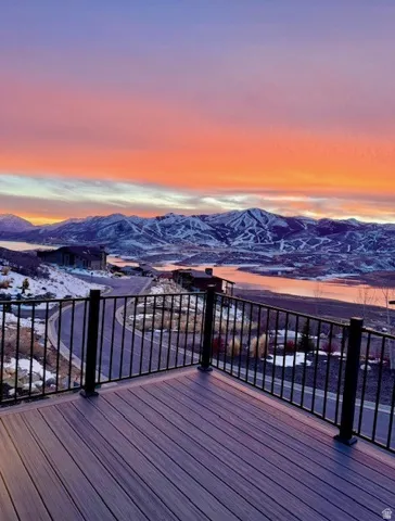 Spacious outdoor deck featuring composite decking and black metal railings