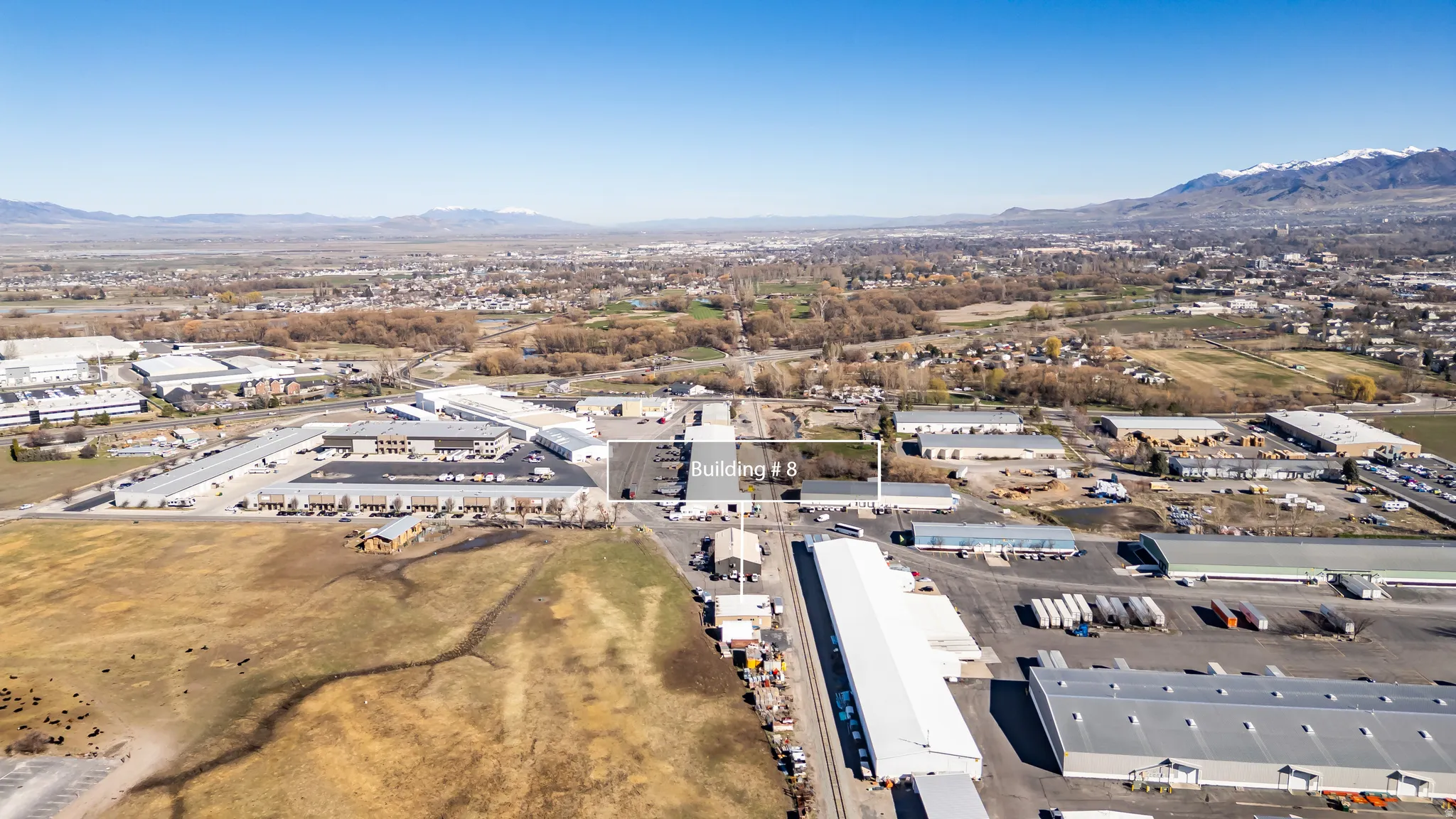 Aerial perspective showcasing industrial properties and surrounding land