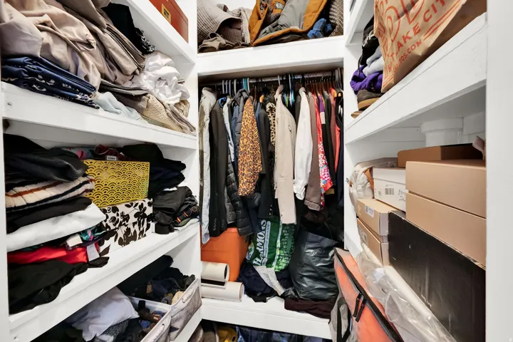 Built-in closet system featuring white shelving and hanging rods