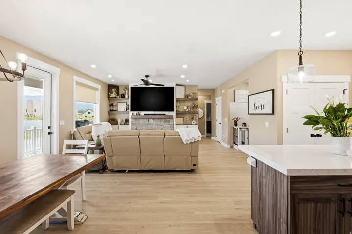 Bright open-concept living area with light wood-finish flooring
