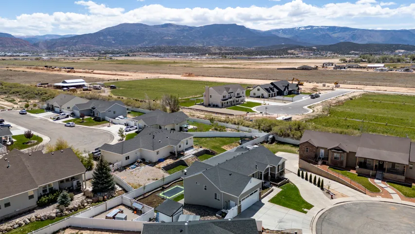 Aerial perspective showcasing residential properties and surrounding undeveloped land