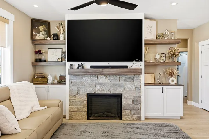 Stone-faced fireplace with a wood-finish mantel and built-in electric insert