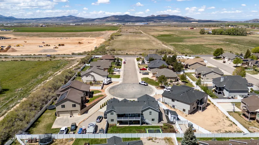 Aerial perspective showcasing a residential cul-de-sac with varied single-family homes, each featuring individual driveways and fenced yards