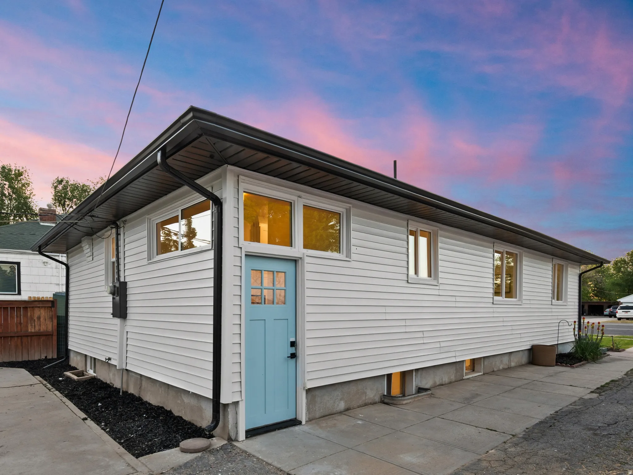 White siding exterior with a light blue entry door
