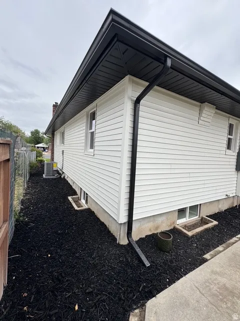 White horizontal siding with contrasting black soffit, fascia, and gutters