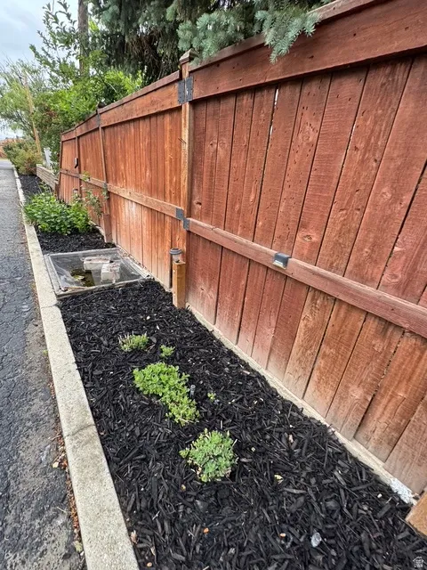 Wood privacy fence with decorative post caps and integrated solar lighting