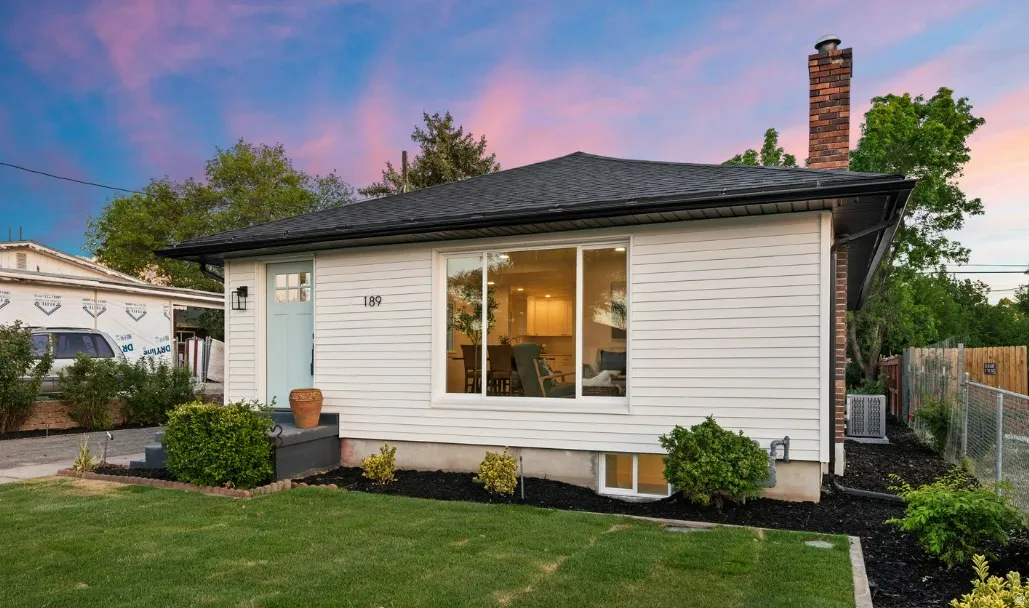 White siding exterior with a light blue entry door