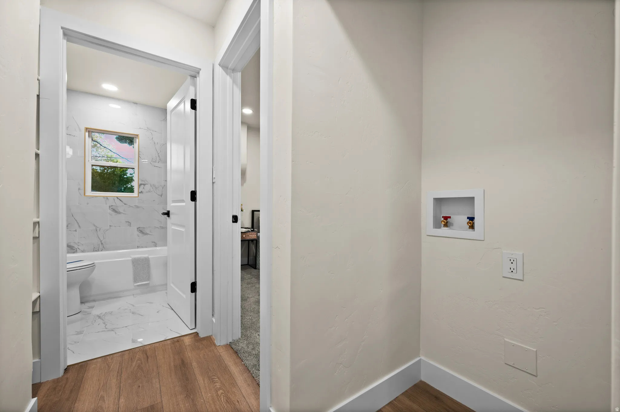 Hallway featuring wood-finish flooring