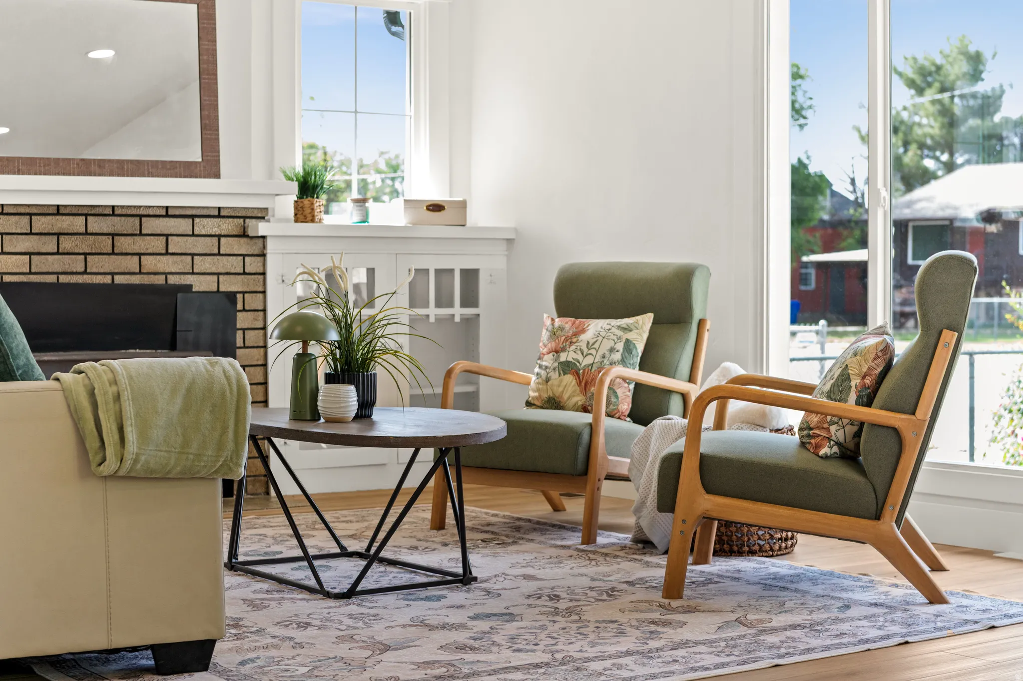 Bright living area featuring wood-finish flooring and a decorative rug