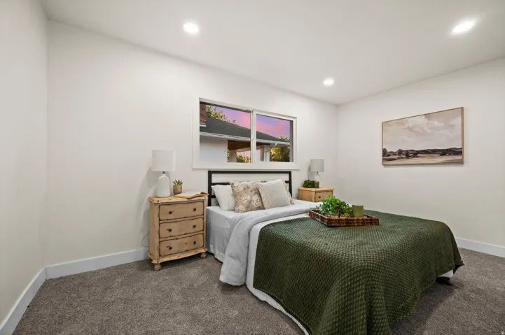 Bedroom featuring plush gray carpet, a white framed window, recessed lighting, and white baseboards