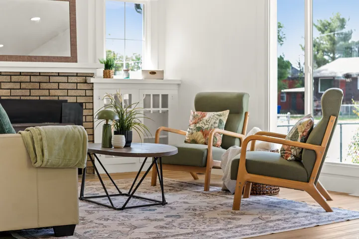 Bright living area featuring wood-finish flooring and a decorative rug