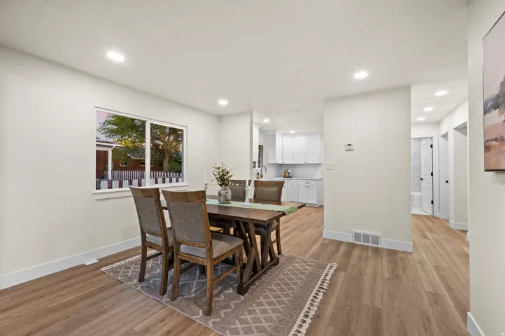 Open-concept living space featuring wood-finish flooring, recessed lighting, and a neutral color palette