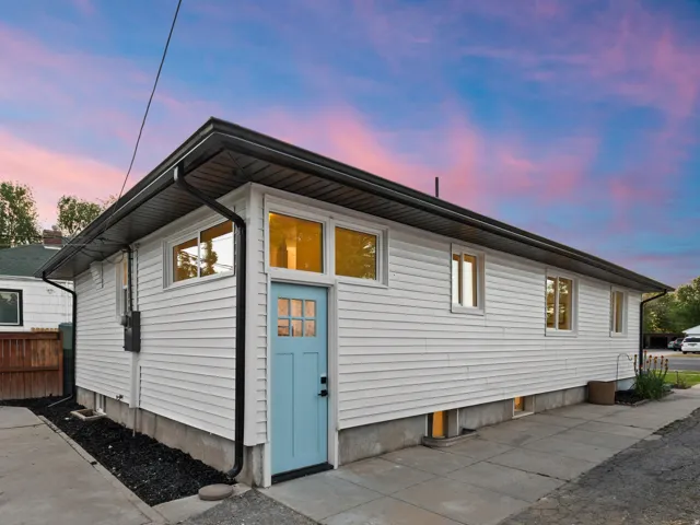 White siding exterior with a light blue entry door
