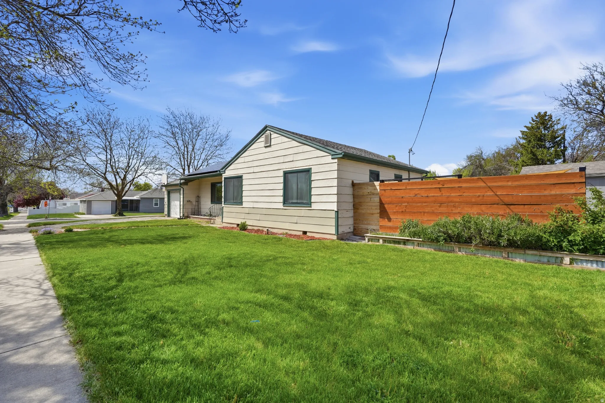 Expansive green lawn with sidewalk access