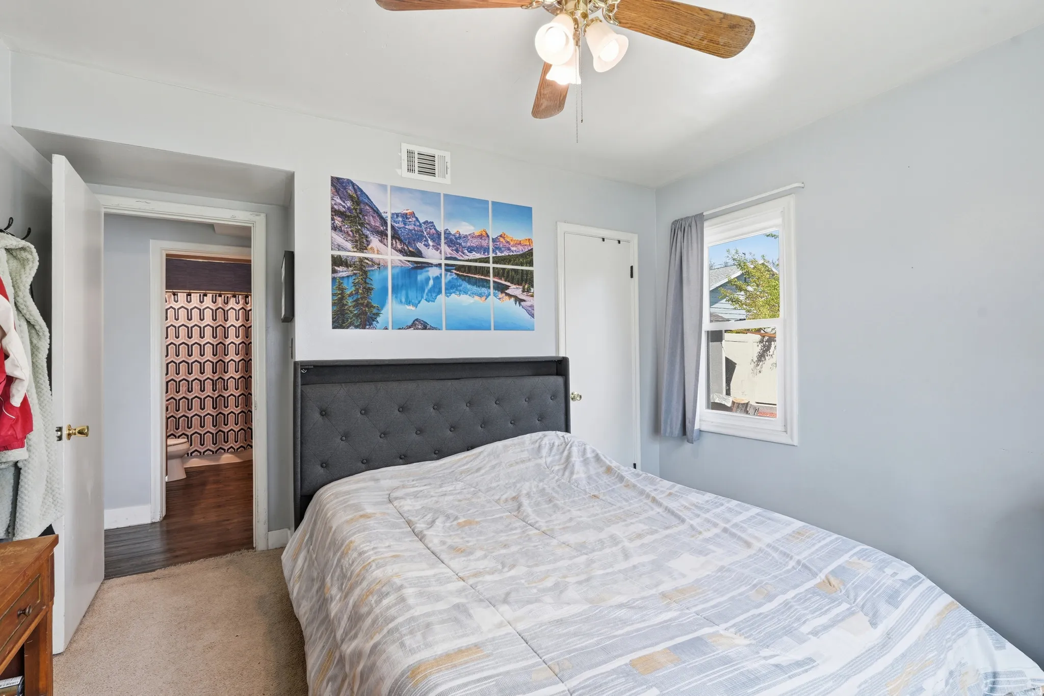 Carpeted bedroom with a ceiling fan, recessed lighting, and a white-framed window
