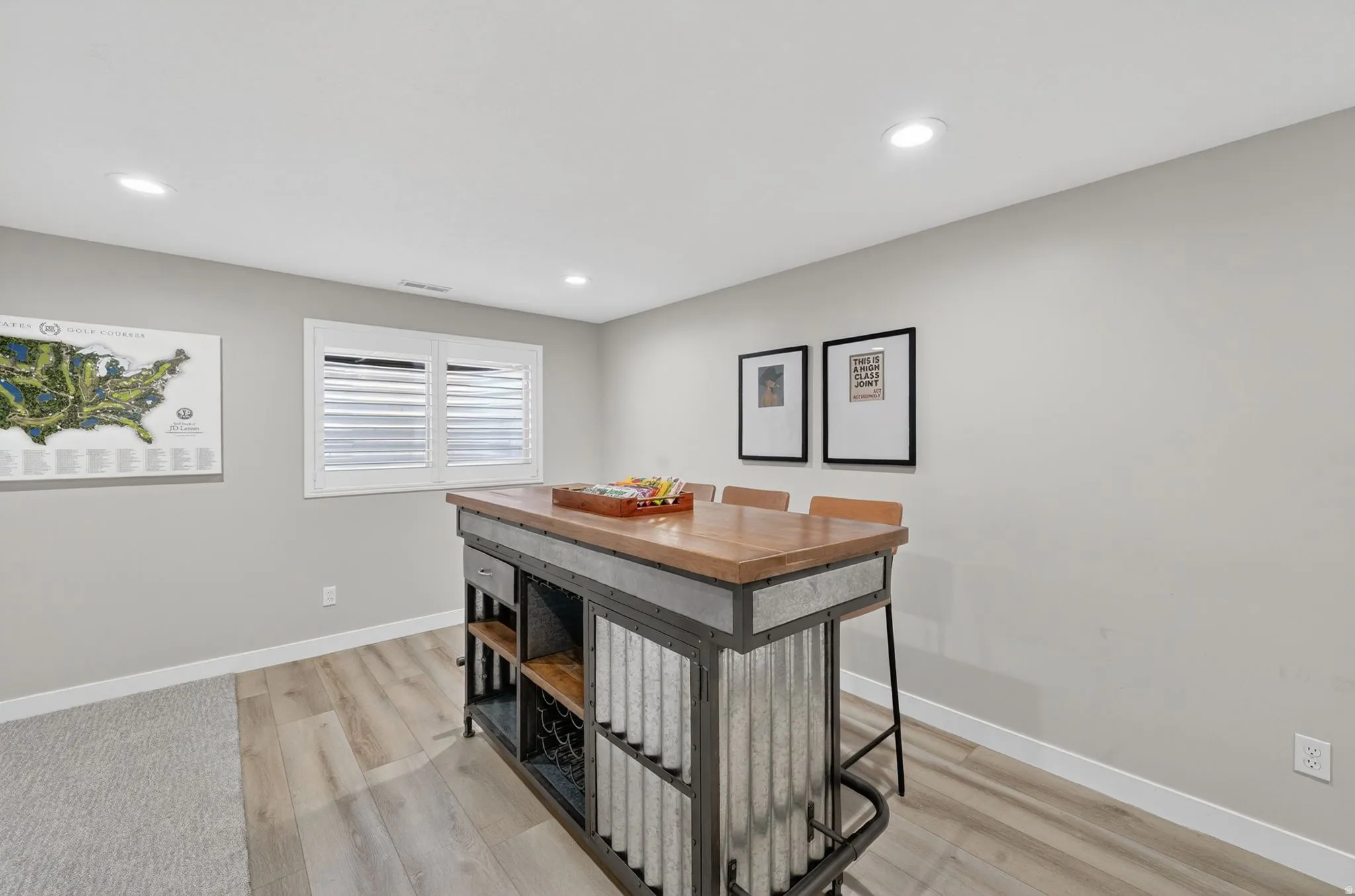Industrial-style island with a wood-finish countertop, corrugated metal accents, and integrated shelving