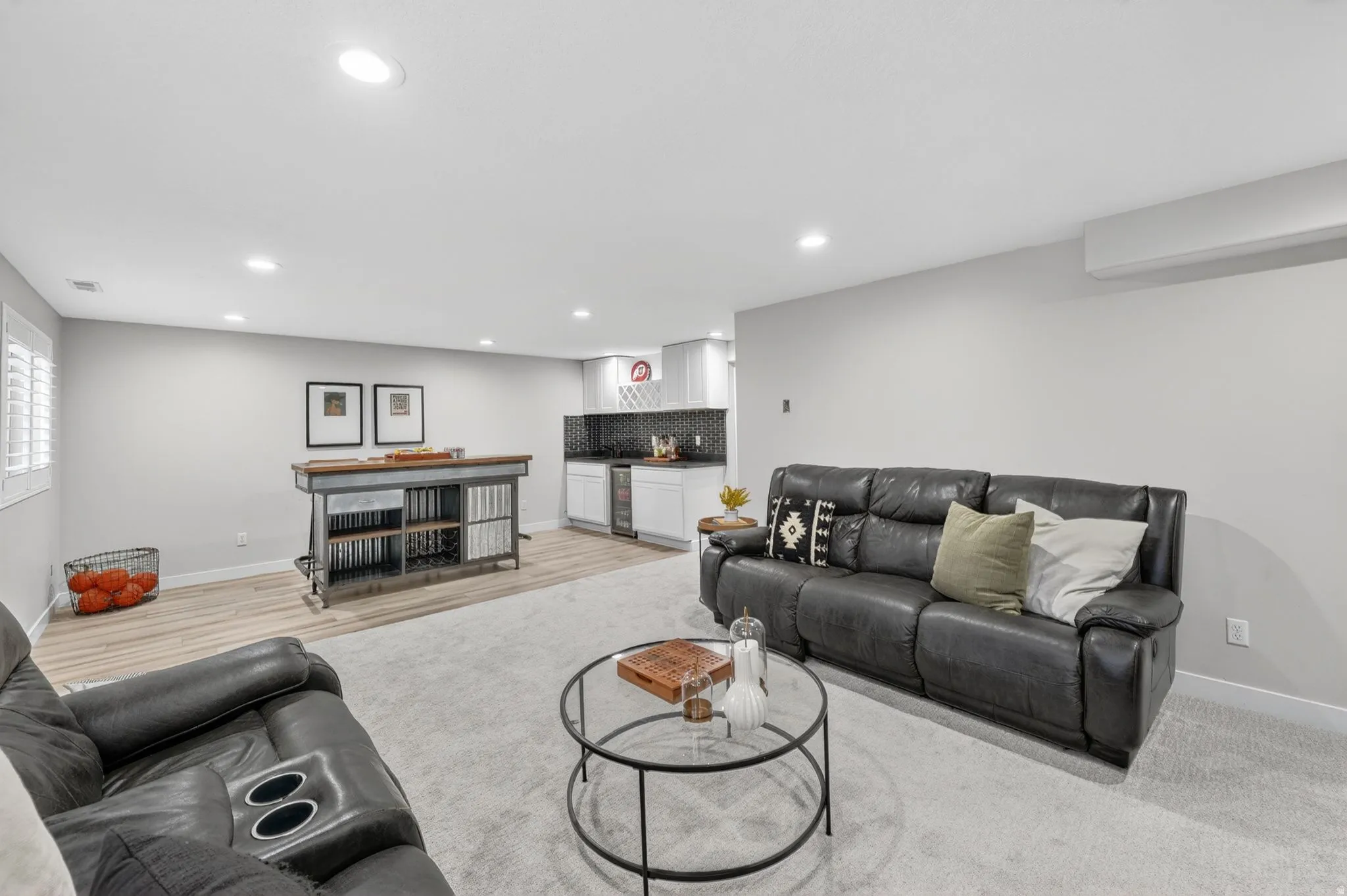Spacious lower-level area featuring recessed lighting, light-toned carpeting, and wood-finish flooring