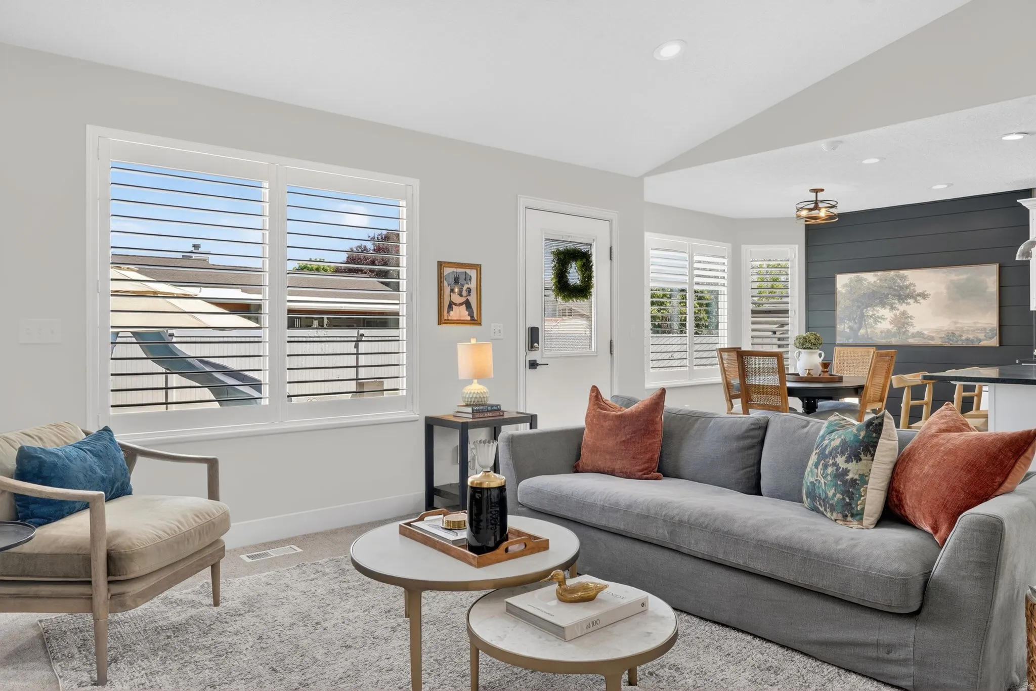 Living area featuring vaulted ceilings and recessed lighting