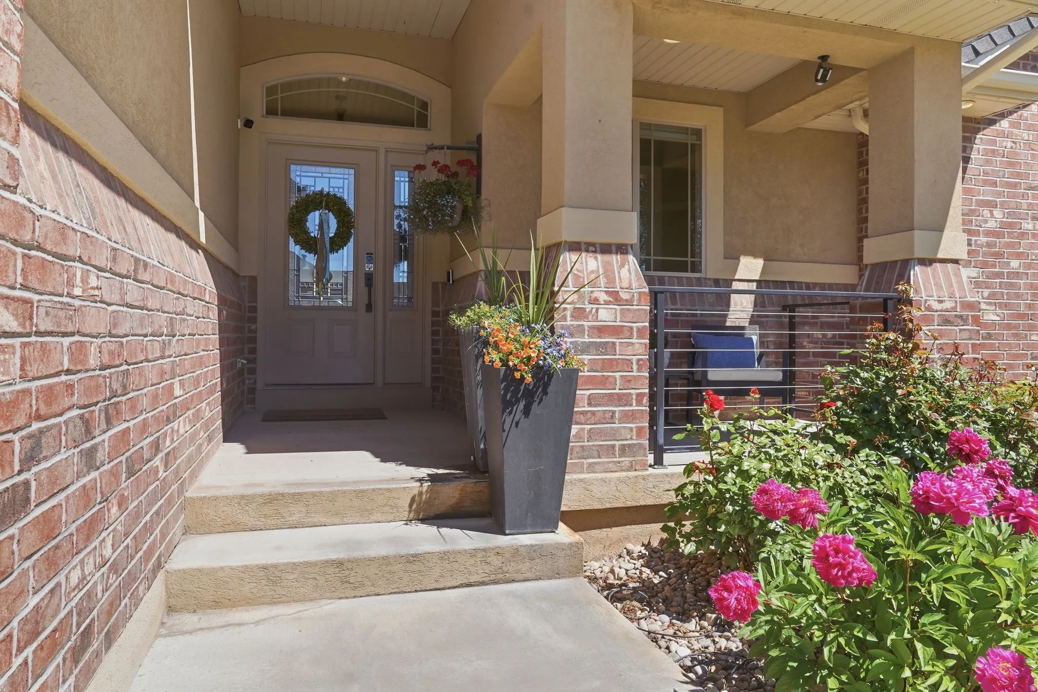 Brick and stucco exterior featuring a covered entryway