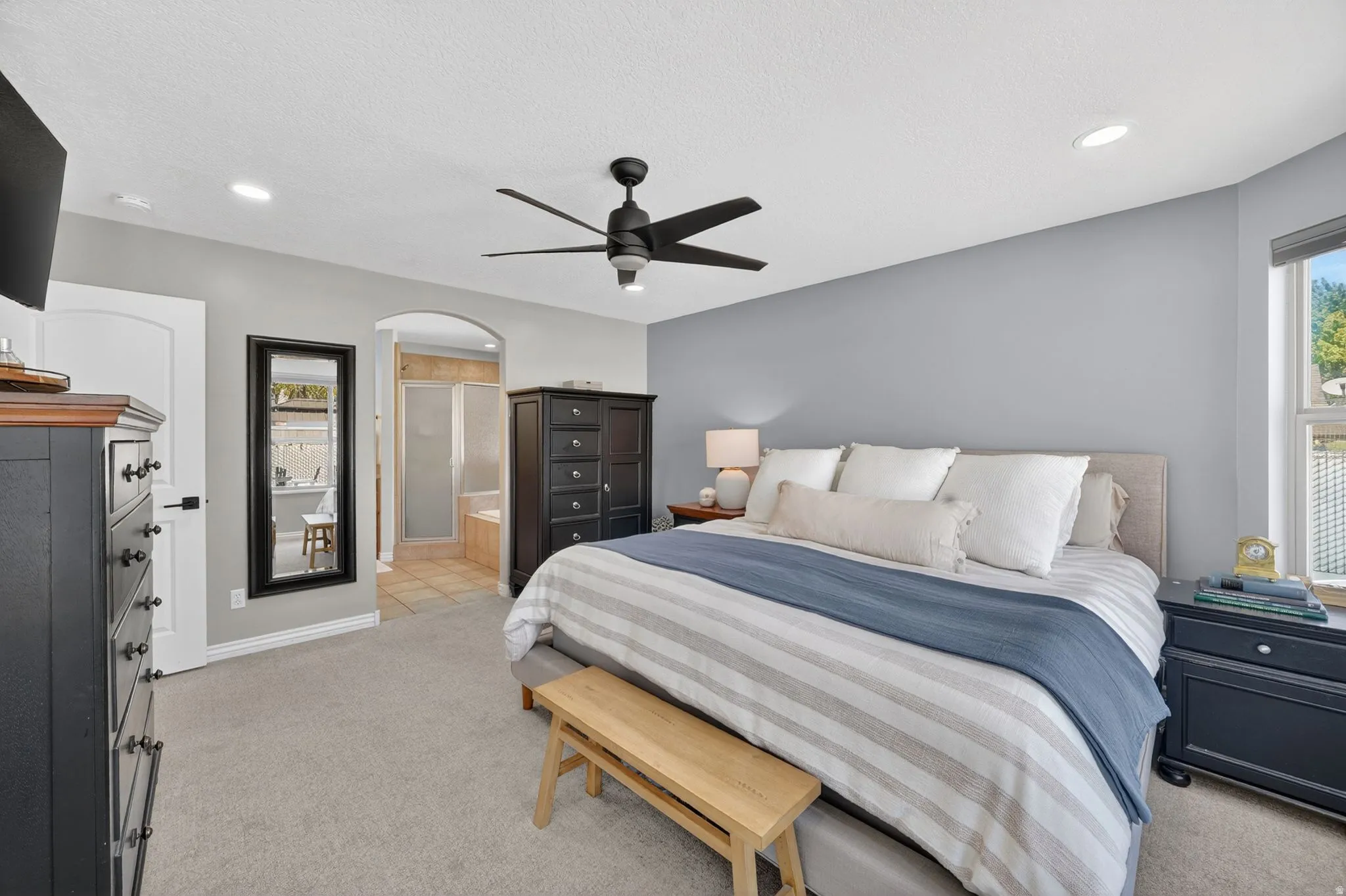 Carpeted bedroom featuring a ceiling fan with integrated lighting, recessed ceiling lighting, and a window with blinds