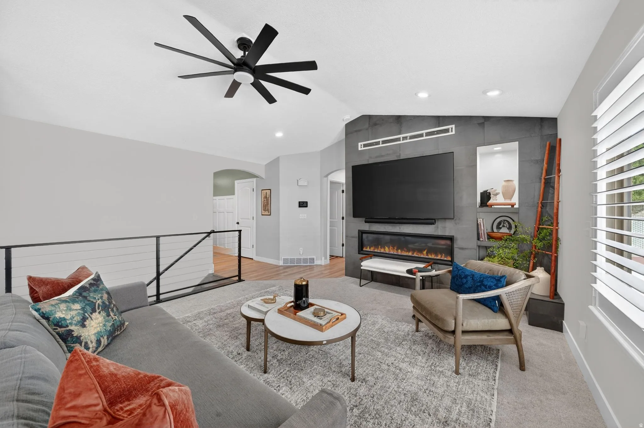 Living space featuring a modern ceiling fan, recessed lighting, and a cable railing system
