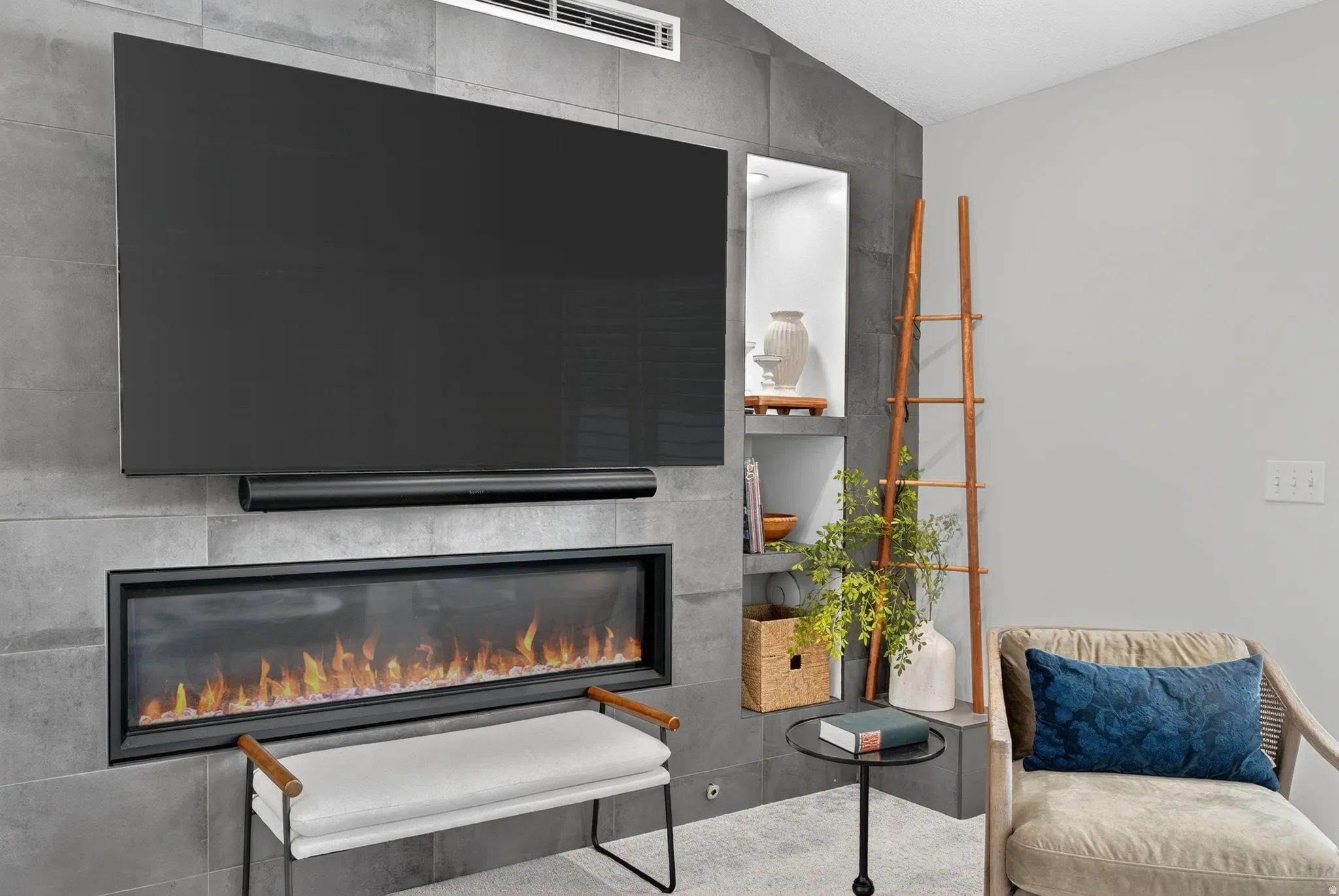 Feature wall with stone-look paneling, integrated linear fireplace, and recessed shelving