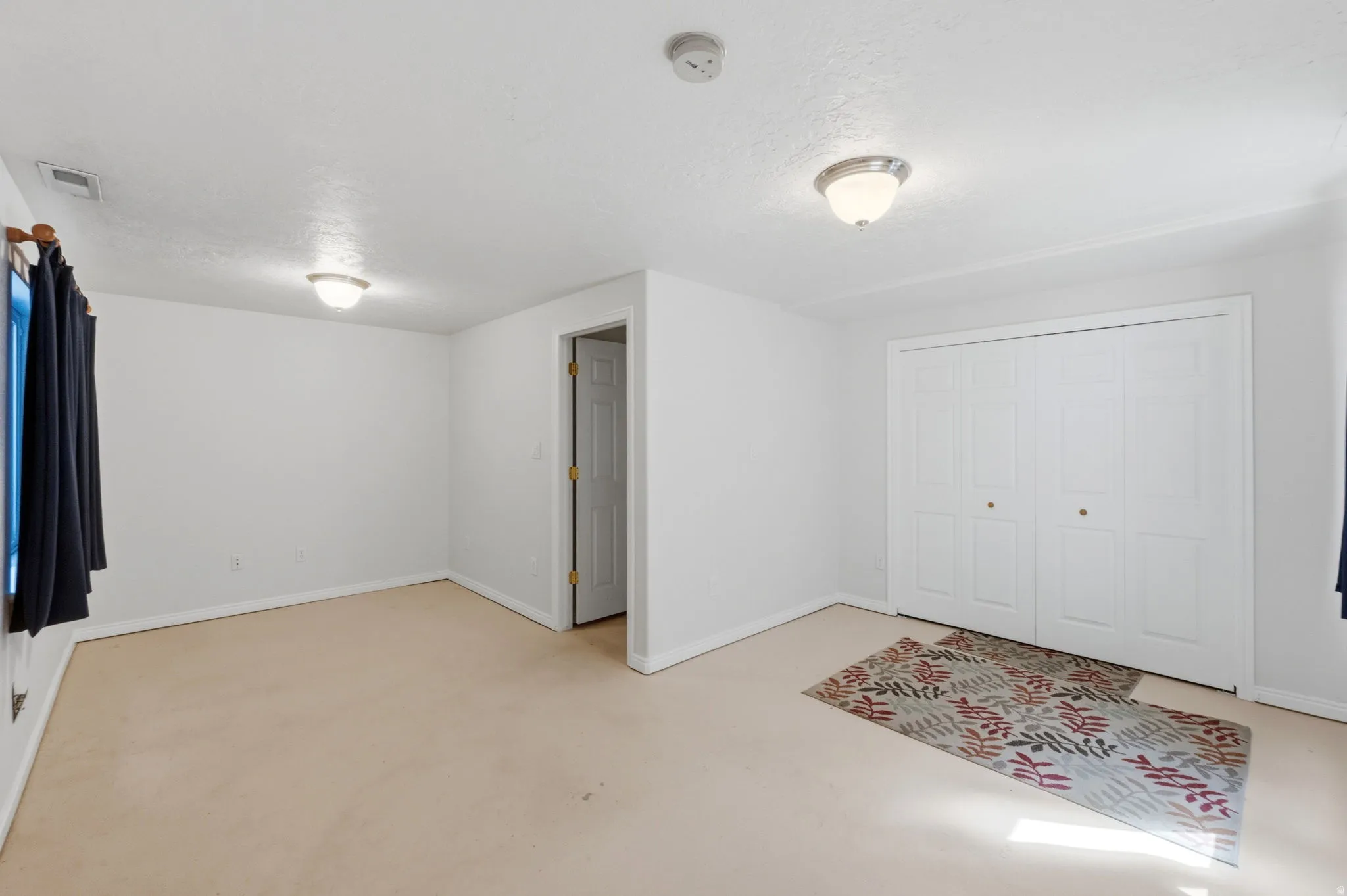 Room featuring neutral carpeting and white walls