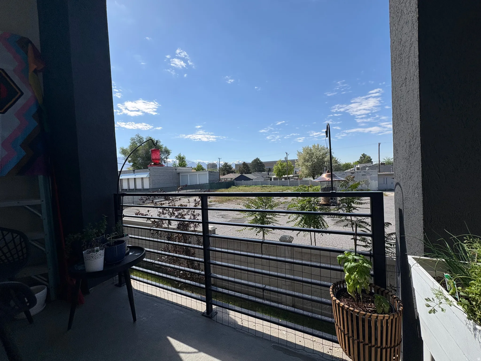 Private balcony featuring a black metal railing and concrete flooring