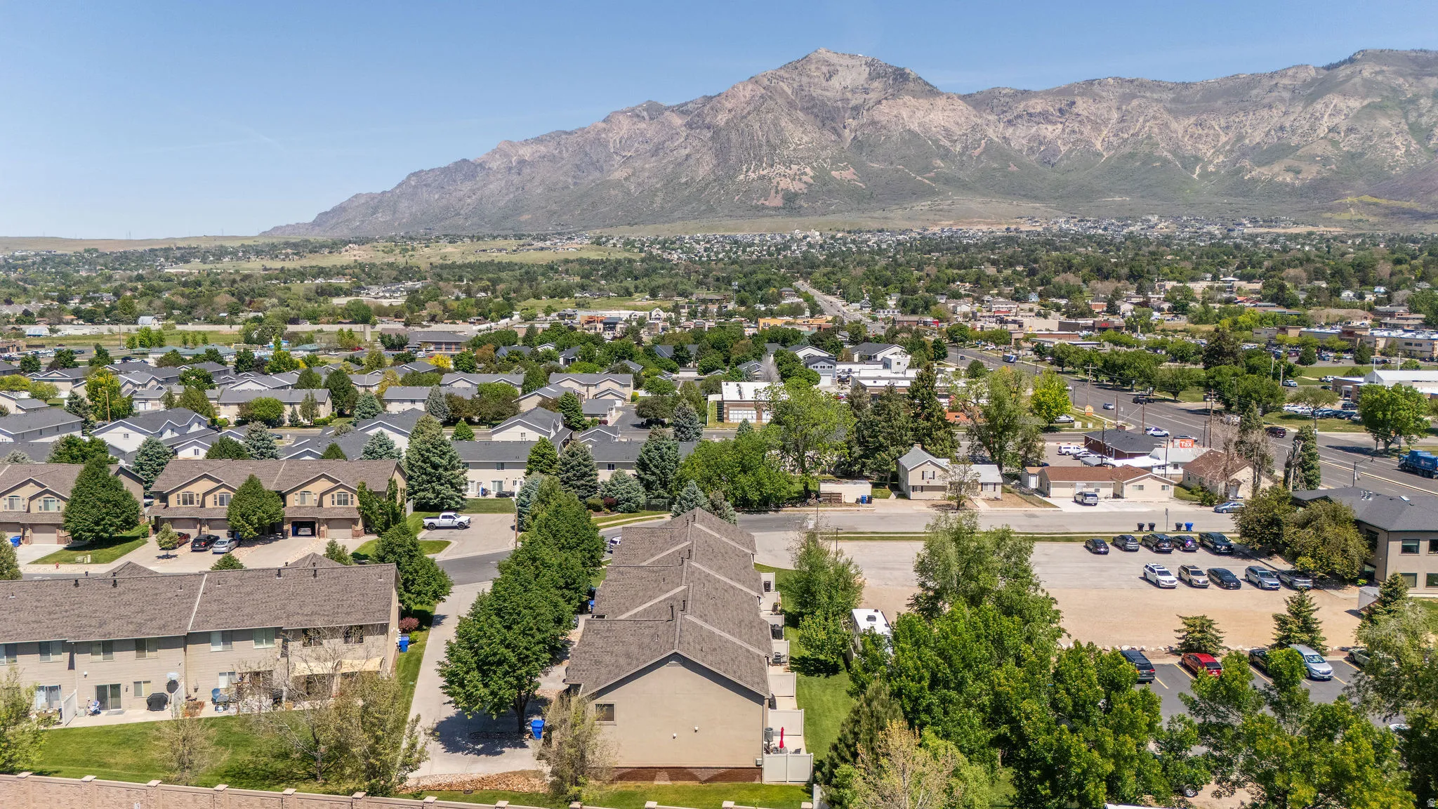 Expansive aerial perspective showcasing residential properties with a mountainous backdrop